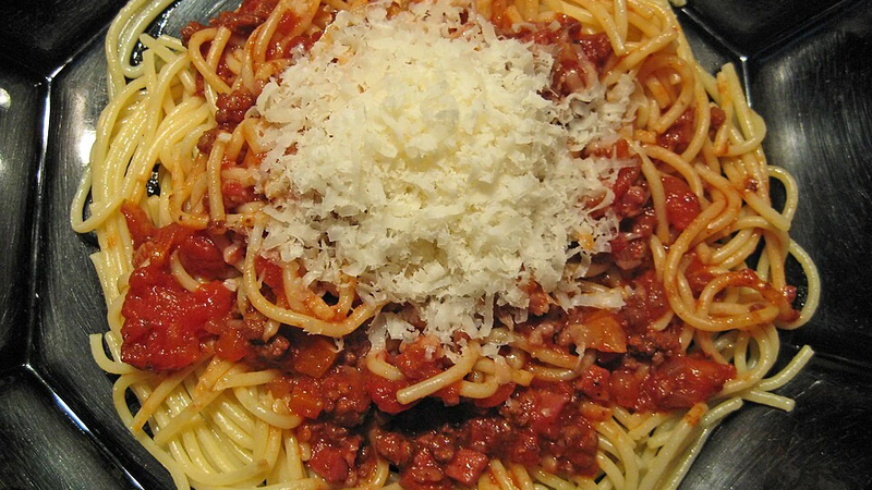 A plate of pasta with beef.