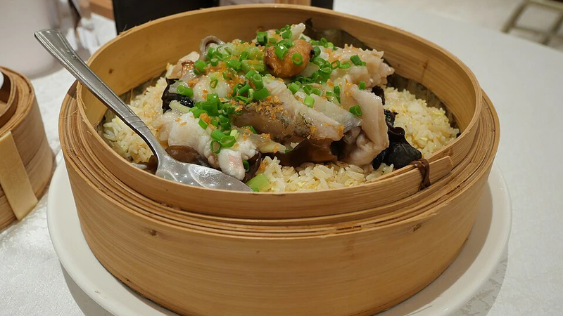 A plate of rice cooked with fresh fish.