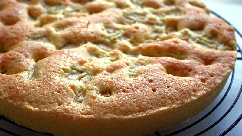 A cake with white chocolate and pear.