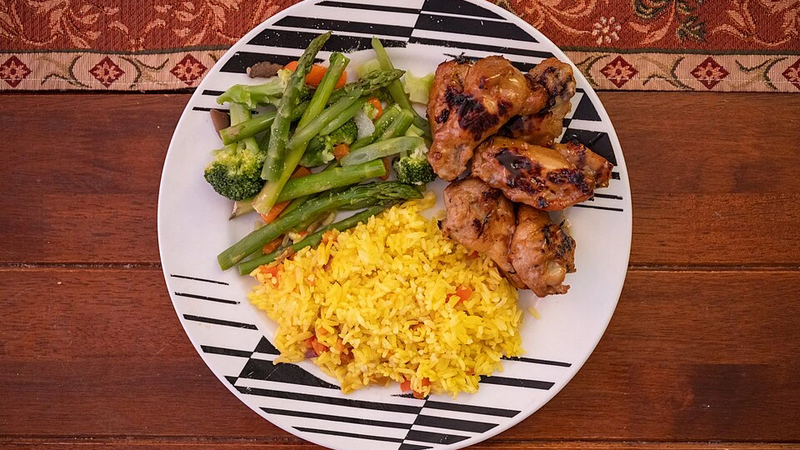A plate of rice with vegetables.