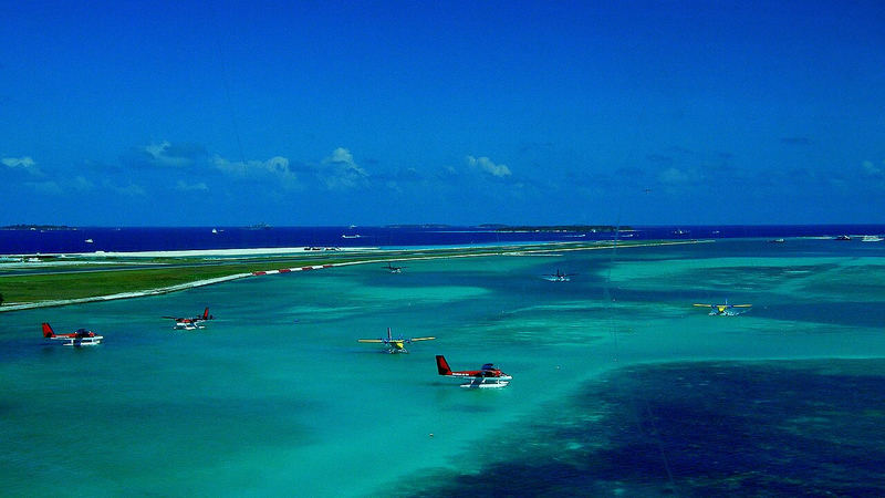 Seaplanes lined up on the water runway near Velana International Airport