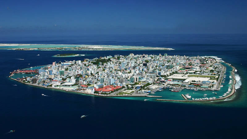 Aerial view of Malé, the densely built capital island of the Maldives, surrounded by deep blue ocean