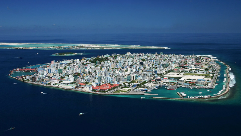 Aerial view of Malé, the densely built capital island of the Maldives, surrounded by deep blue ocean
