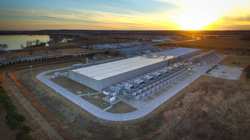 Aerial view of a large Google data centre building beside fields at sunset in Council Bluffs, Iowa