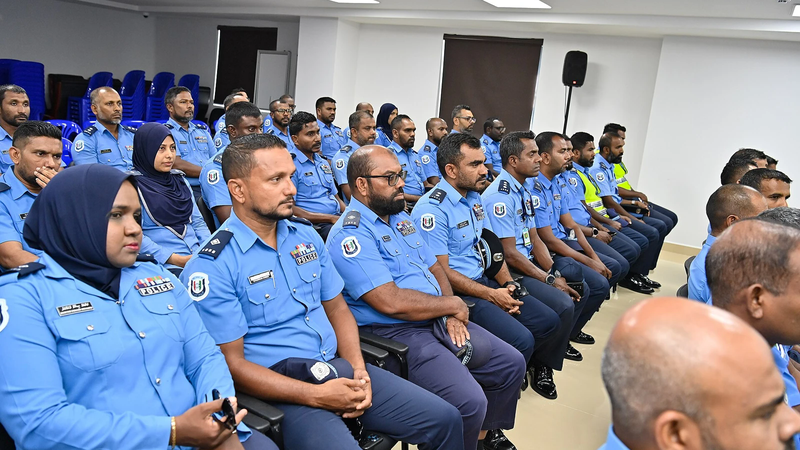 Rows of uniformed Maldives Police officers seated in a meeting room