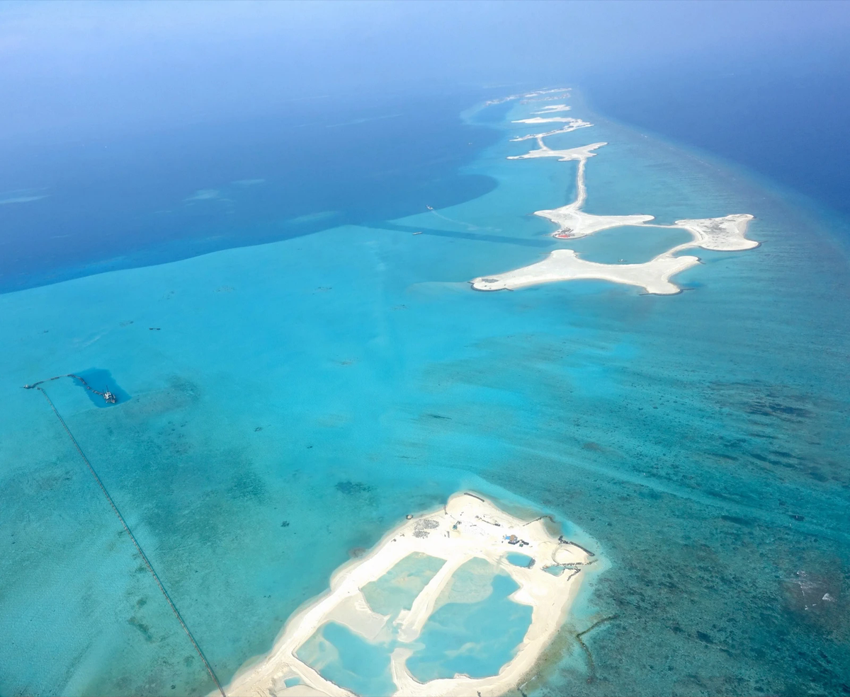 Aerial view of new land being reclaimed from a lagoon in Kaafu Atoll